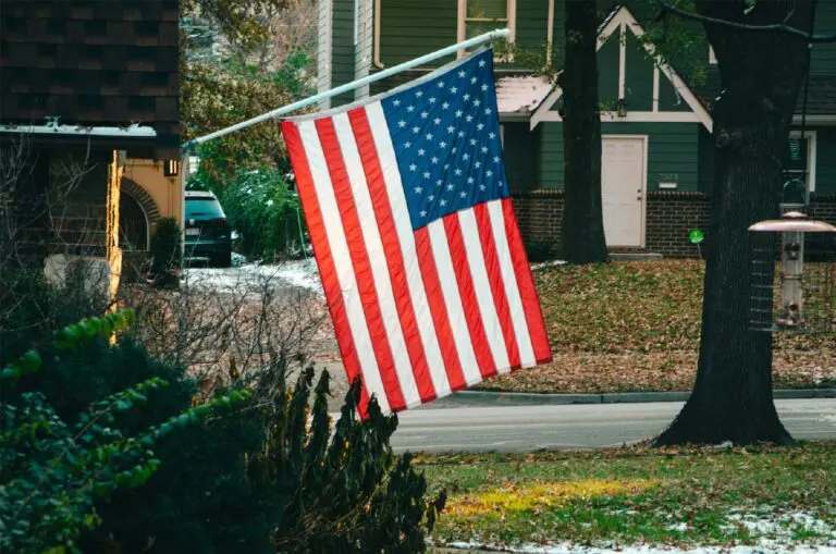 American flag mounted on home in happy neighborhood